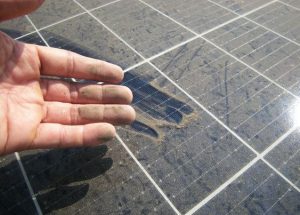Dirty Hand after Rubbing Dusty Solar Panel
